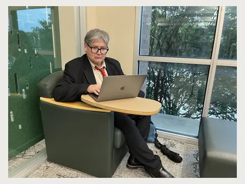 Herbert Midgley working at a laptop in East Texas.