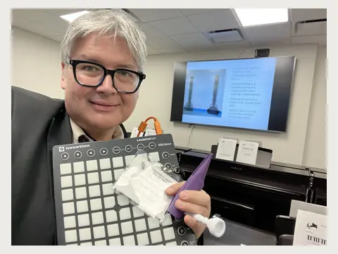 Herbert Midgley demonstrating a music technology controller.
