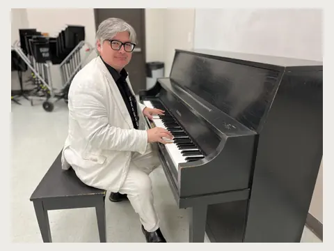 Herbert Midgley playing piano.