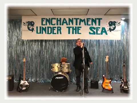Herbert Midgley on a stage prepared for a live music event.
