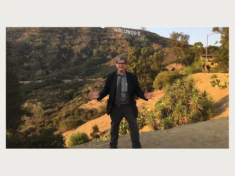 Herbert Midgley standing near the Hollywood sign.