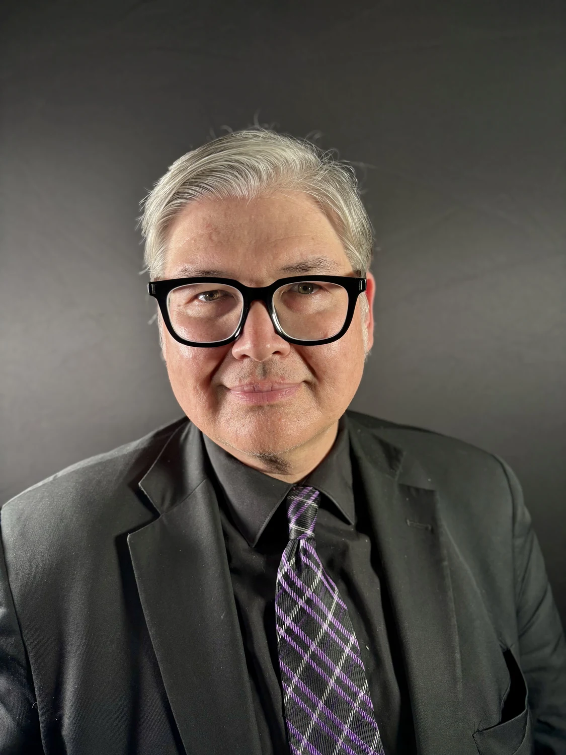 Herbert Midgley in a dark suit and glasses