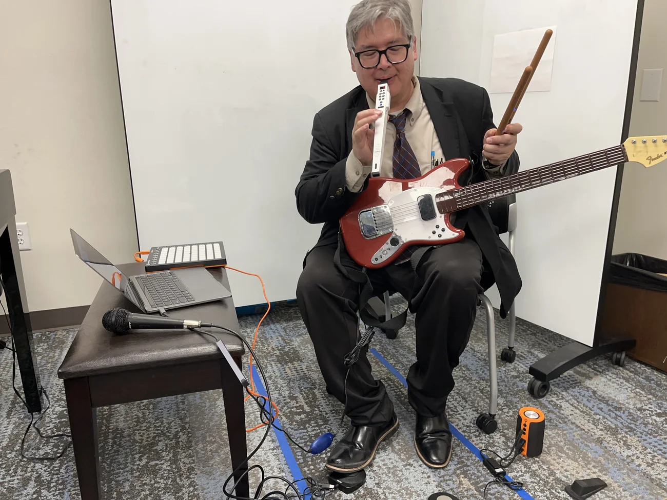 Herbert Midgley demonstrating music technology with guitar and electronics